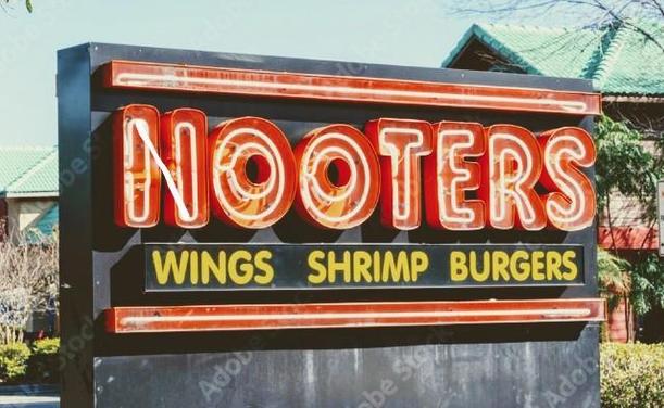 A neon sign that reads "Nooters" in orange and white neon, with "wings shrimp burgers" in smaller yellow print below.