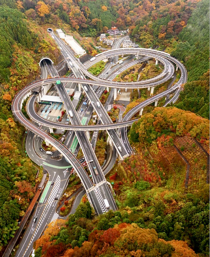 The Takaosan Interchange is an intricately designed highway interchange that has garnered attention for its complex & seemingly surreal appearance. Photo taken during autumns with the surrounding landscape in full autumn colours.