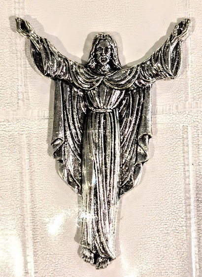 Jesus, arms outstretched, as if on the cross but head held high, and dressed in robes