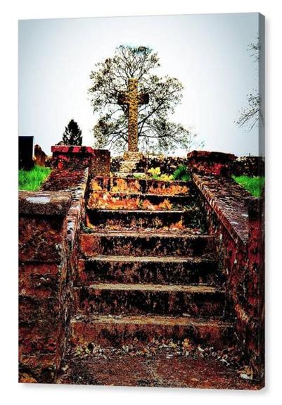Colour adjusted portrait photograph showing a short flight of stone steps leading up to a stone cross with a graveyard.  The image is shown printed upon a box canvas.