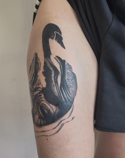 Swan tattoo on a thigh