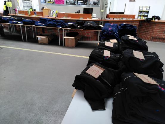 Tables full of EH22 branded shirts and zippers