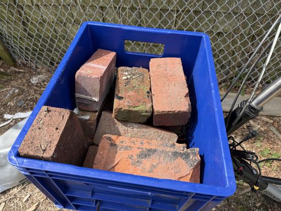 Red bricks in a cargo box on the front of a Workcycles FR8 bicycle.