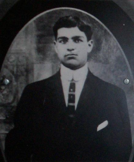Black and white photo of Modestino Valentino, looking straight ahead, in a stiff collar and suit.