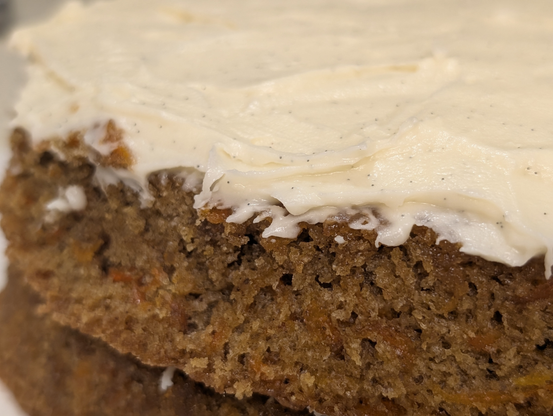 Close-up of the frosting, bespeckled with vanilla bean seeds, and the cake texture.