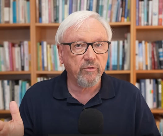 A middle aged white man with glasses and grey hair