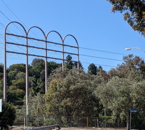 Pylons with rounded tops carrying power lines