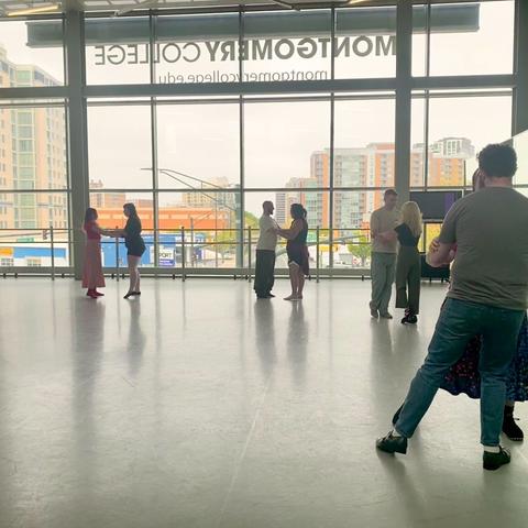 4 couples in practice embrace (hands to arms) practicing moving and walking. We can see pairs of matching pointed toes in two couples, while the other two are lifting a foot to move.