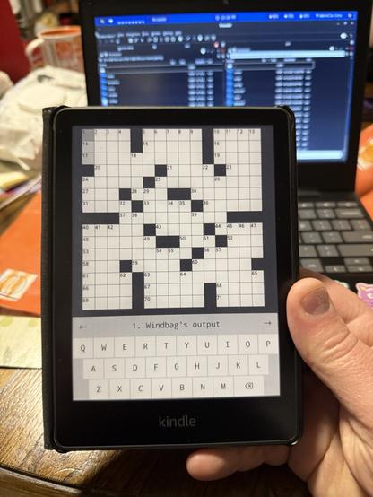 Kindle paperwhite 11th gen. 2023
Screen displays a crossword puzzle. 
The clue to decipher says, “ windbag’s output”