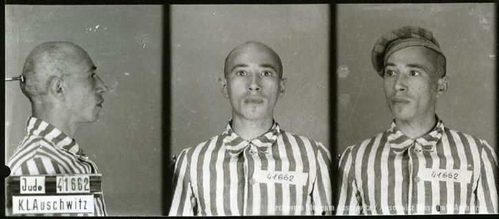 A mugshot registration photograph from Auschwitz. A man with a shaved head wearing a striped uniform photographed in three positions (profile and front with bare head and a photo with a slightly turned head with a hat on). The prisoner number is visible on a marking board on the left.
