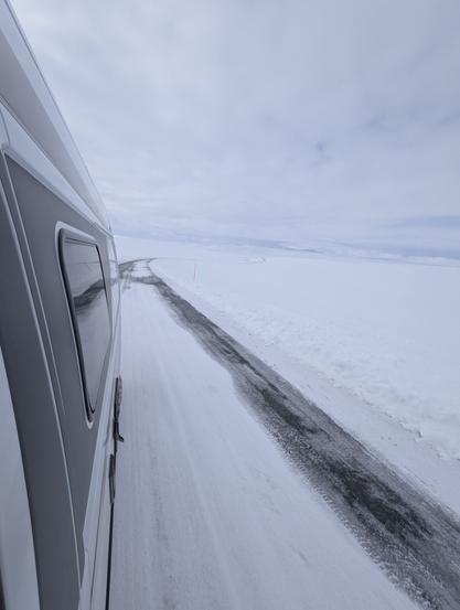 Rear view from the van, over a snowy road
