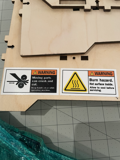 Photo of the warning sign stickers on the Makerbot Replicator 1