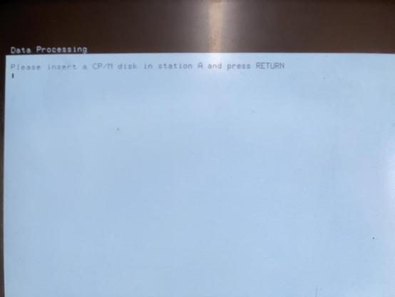 The CompuPak 'software interface' disk booted and showing 'Please insert a CP/M disk in Station A and press RETURN'. Note the 'station A' in CP/M nomenclature, not STATION ONE.