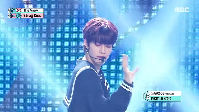 Seungmin performing in his dark blue sailor outfit with glitter under his eyes