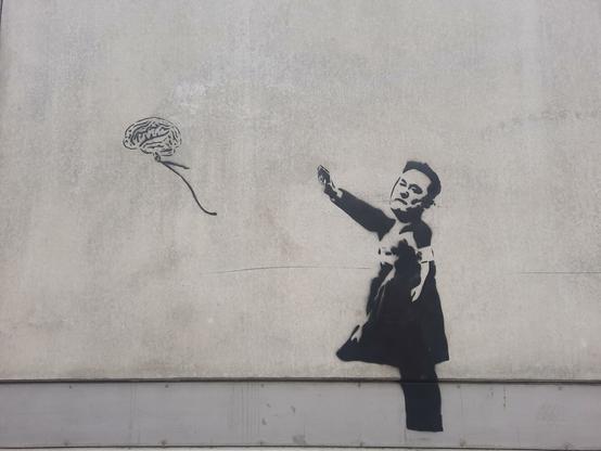 Musk painted on a wall with a dress. He released a balloon in the shape of a brain