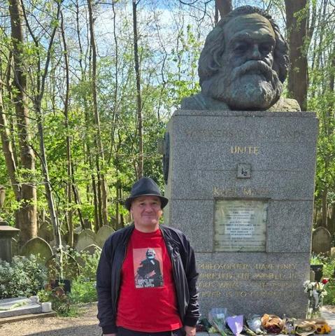 Me, standing in front of the grave of Karl Marx. The red T-shirt that I’m wearing has  Marx on it and the caption says “I warned you that this would happen” in a faux Cyrillic script.
