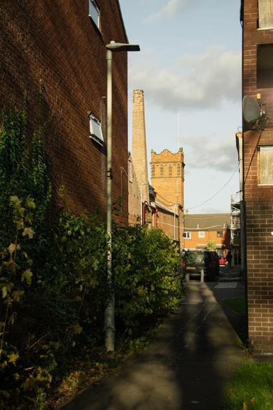 A view from between a passage-way between buildings towards the Bellfoundry's ringing tower.