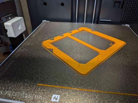 A failed 3D print. The infill is not adhering properly, resulting in blobs of plastic all over the place.