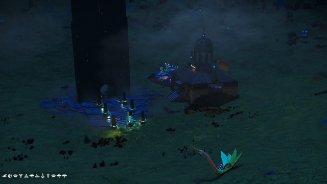 A shot from the hillside looking down on the portal and building, with one 'dragon' sat on the grass in front.