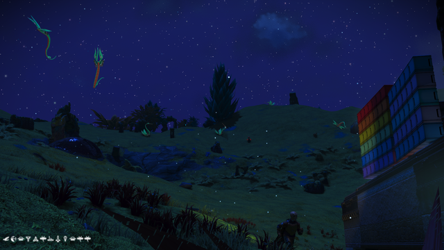 A third shot of more of the 'dragons' flying in the night sky behind the stone building.