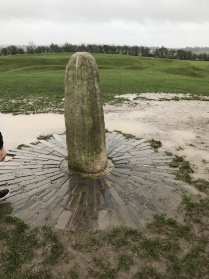 A wet and cold single standing stone of the Hill of Tara.