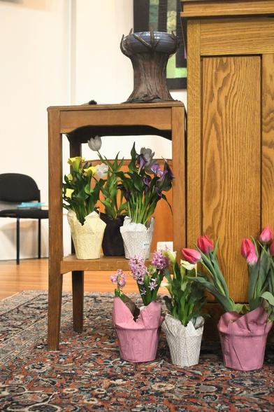 A picture showcasing all the flowers honoring the dead. Tulips and daffodils and other flowers.