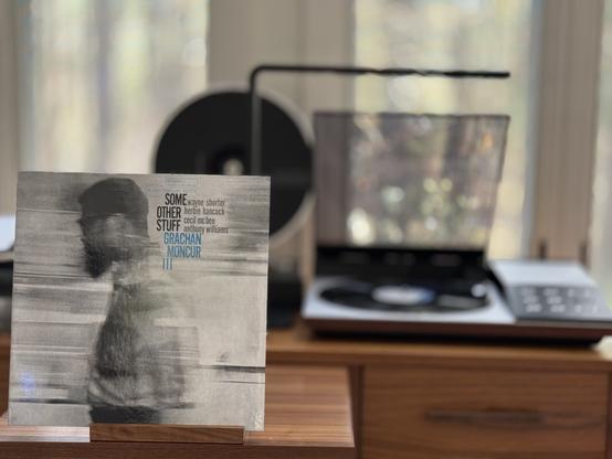 Grachan Moncur III - Some Other Stuff Lp cover.

A black and white, blurry shot of Moncur, facing left, waist to top of head.

The black LP plays on a vintage, restored Bang & Olufsen Beogram 8002 linear-tracking turntable to the right.