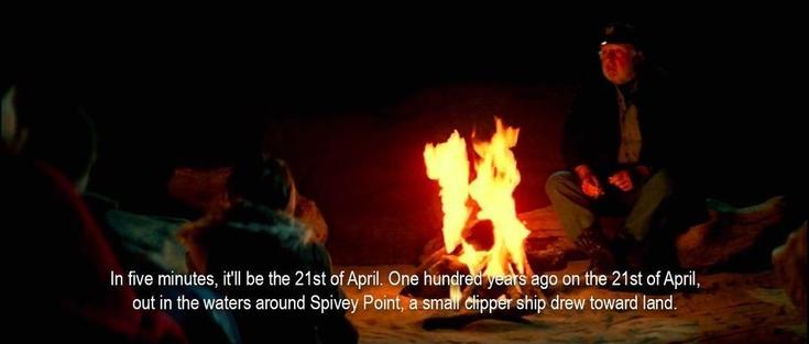 An old sailor sits next to a campfire, speaking to a group of children. “In five minutes, it'll be the 21st of April. One hundred years ago on the 21st of April, out in the waters around Spivey Point, a small clipper ship drew toward land.”