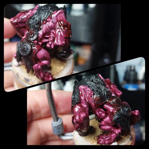 Gross blood red to bluish pink highlighted skin on a weird golem like lion man construct