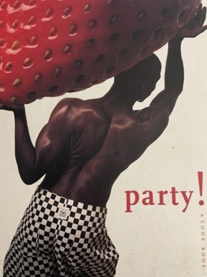 The cover - a dark skinned man attired in just black and white checked trousers, hefting a giant red strawberry above his body.