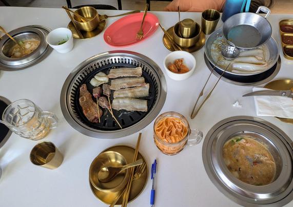 An assortment of meats and seafoods at the table while dining at La Kang Hot Pot.