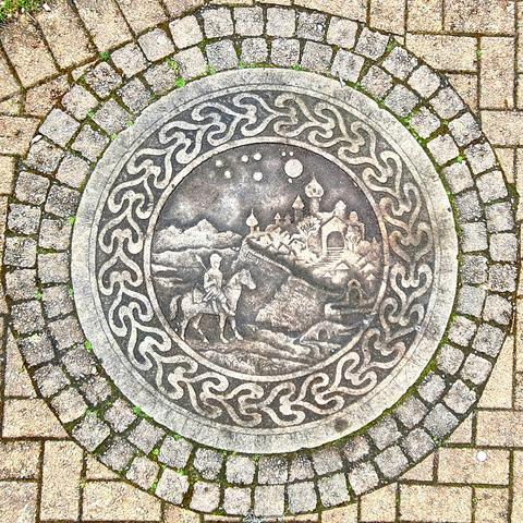 A decorative panel set into the ground in a Glasgow park.