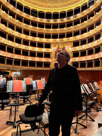 Conductor Elia Andrea Corazza in the orchestra pit conducting L'Elisir d'amore by Gaetano Donizetti. Teatro Massimo, Palermo, Sicily, Italy.