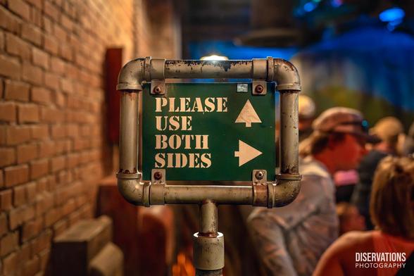 A Tower of Terror queue sign telling guests to "Please use both sides"