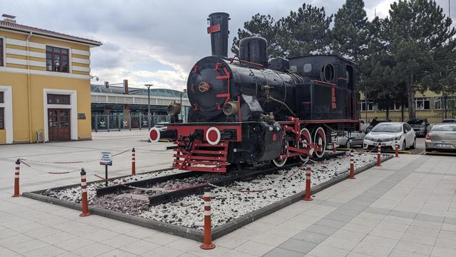 The cute steam locomotive in front of the station.