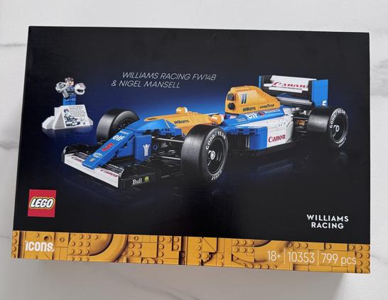 The packaging for the Lego set of the Williams Racing FW14B as driven by Nigel Mansell. The Red 5 on the nose of the car. 
There is a minifigure of Nigel Mansell on a podium.