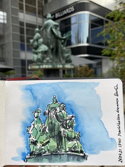 A fountain with some statues of market vendours, in front a sketchbook with a coloured painting of them.
