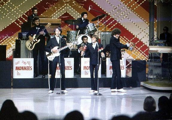The Monkees in their trio form, appearing with backing band The Goodtimers on their April 24, 1969 appearance on The Joey Bishop Show. Michael Nesmith sings lead, bearing his iconic white Gibson SG guitar