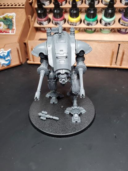 Photo of an assembled Knight Armiger Helverin sitting in front of paint storage on a desk.