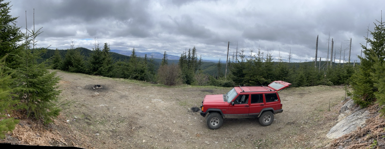 Panoramic view of a mountain side campsite with view