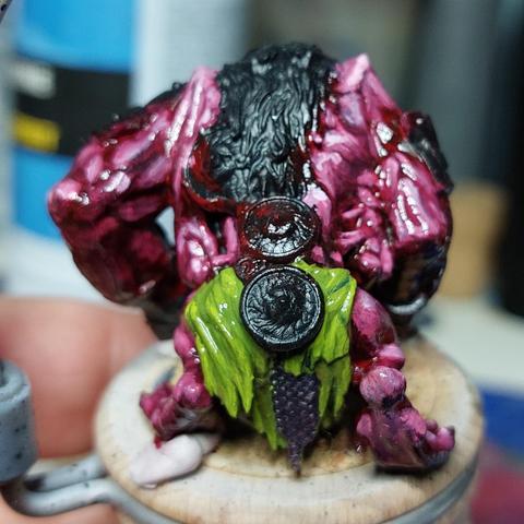 The back of the murderkitty, which is an unhealthy looking mass of muscle and an unpainted mane of hair. There's a newly painted green loincloth with inexplicable arse shield and rectal chain mail.