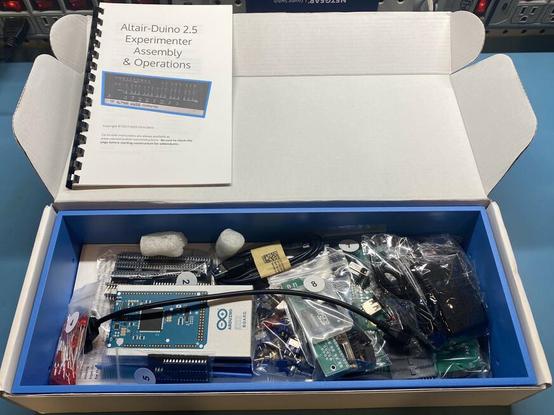 An open box showing an Altair-Duino Experimenter kit, disassembled with the instruction manual visible.