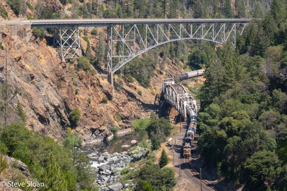 Westbound at Pulga
Union Pacific (UP) 7482 leads a westbound 2+2+1 manifest in the Feather River Canyon navigating the over and under bridges at Pulga, CA on a very hot Thursday, July 11, 2024.
UP 7482 is a GE ES44AC. Reportedly: it was built by 2011 builder number 60477.