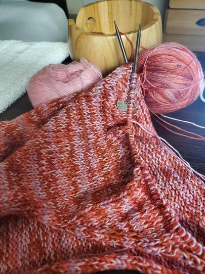 Longer shot of knitted work, silver-toned bird stitch marker visible