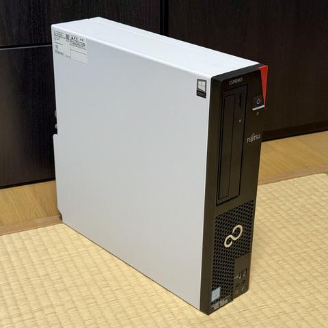 A Fujitsu ESPRIMO PC, the side case is white and the front is black
