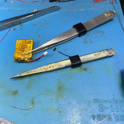 Tweezers apply precise pressure via a sliding collar.