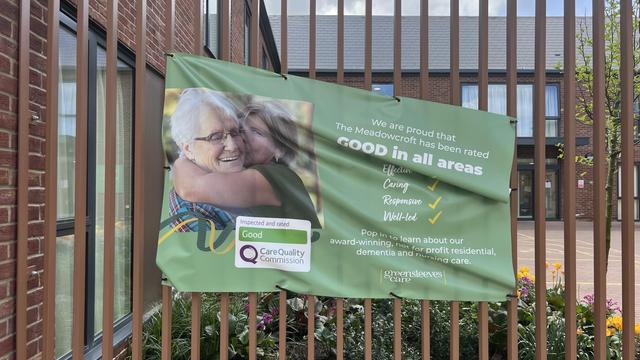 Promotional Sign outside a care home that is falling down.