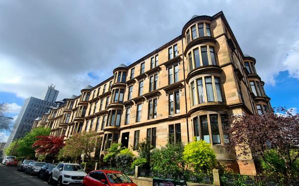 A block of blonde sandstone Glasgow tenements.
