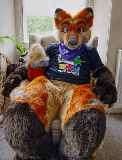 Terrence is chilling in a chair wearing a CFZ T-Shirt for the multiverse