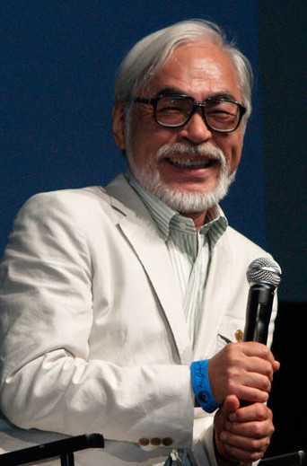 Photo of Hayao Miyazaki holding a microphone.